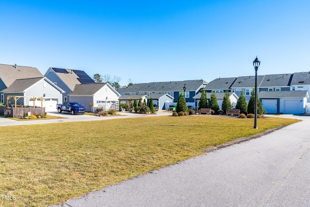 exterior space with a garage and a front lawn