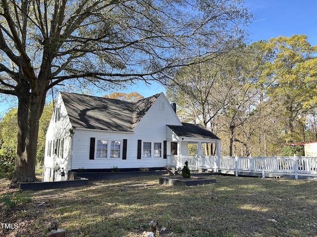 view of front facade with a front yard and a deck