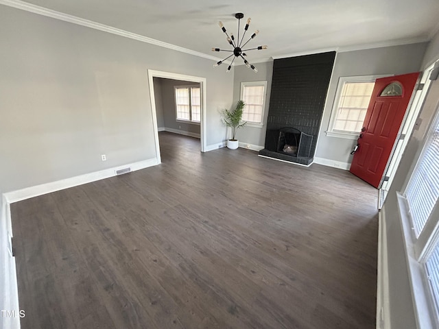 unfurnished living room with a healthy amount of sunlight, ornamental molding, and dark wood-type flooring