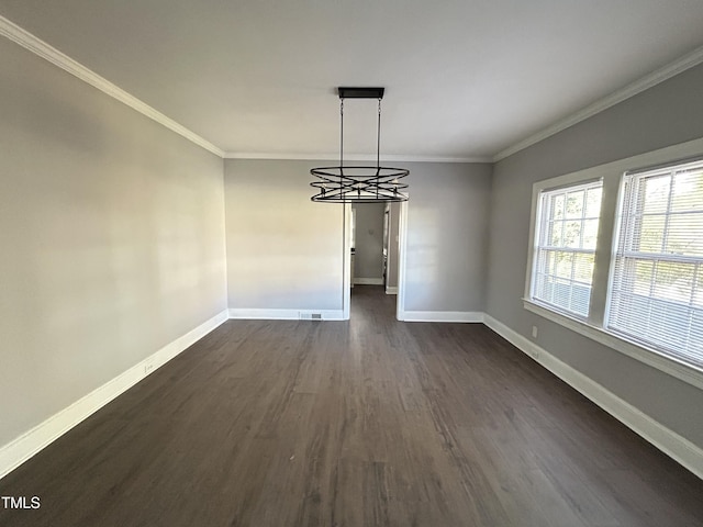 unfurnished dining area featuring a notable chandelier, dark hardwood / wood-style flooring, and ornamental molding