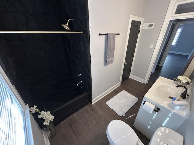 bathroom featuring vanity, wood-type flooring, and toilet