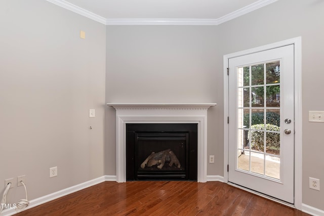 unfurnished living room featuring hardwood / wood-style floors, plenty of natural light, and ornamental molding