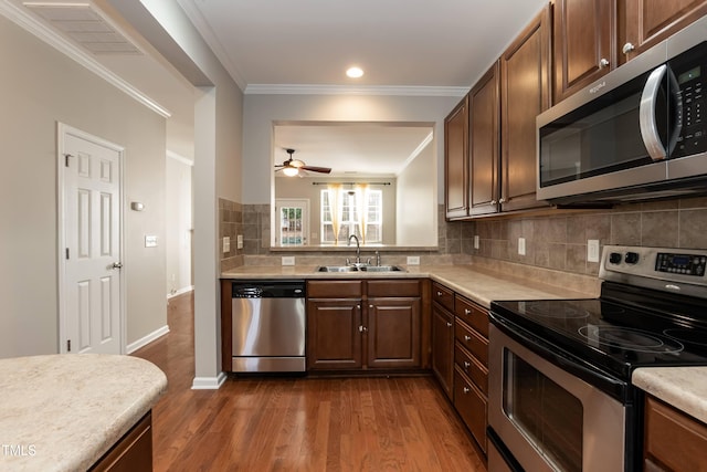 kitchen with ceiling fan, sink, stainless steel appliances, dark hardwood / wood-style flooring, and crown molding