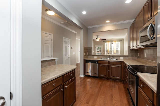 kitchen featuring tasteful backsplash, sink, stainless steel appliances, and dark hardwood / wood-style floors