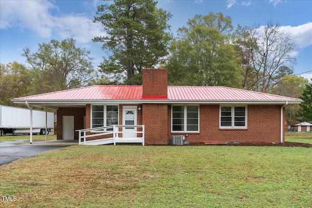 view of front facade with central AC, a front lawn, and a carport