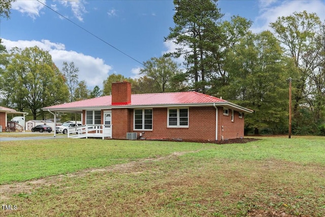 back of house with central AC, a yard, and a porch