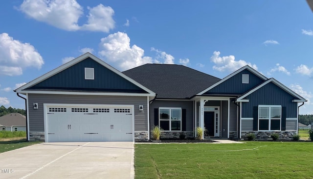 craftsman inspired home with an attached garage, concrete driveway, stone siding, board and batten siding, and a front yard