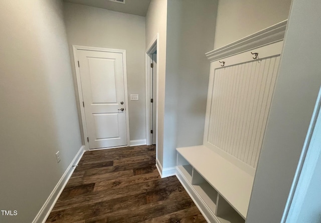 mudroom featuring dark wood-type flooring and baseboards