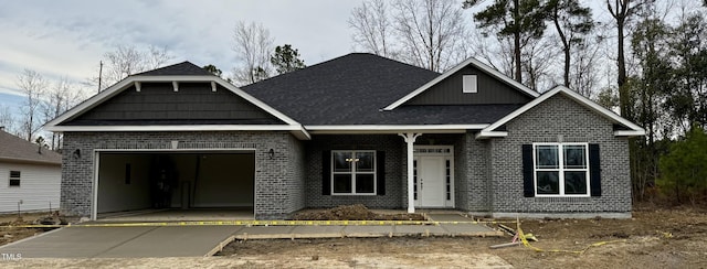 view of front of home featuring concrete driveway, brick siding, and an attached garage