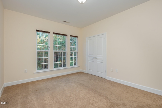 empty room with light colored carpet