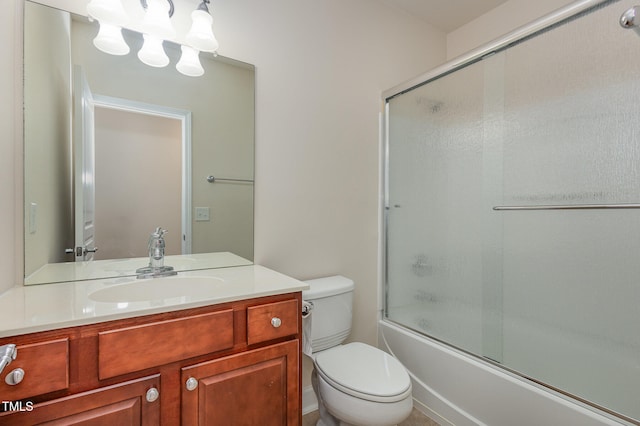 full bathroom featuring vanity, enclosed tub / shower combo, and toilet