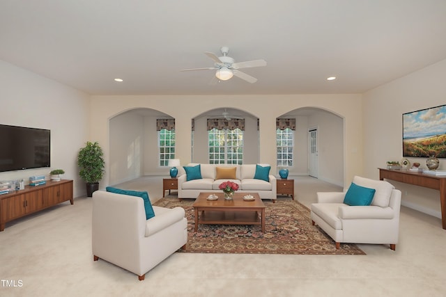 carpeted living room with ceiling fan