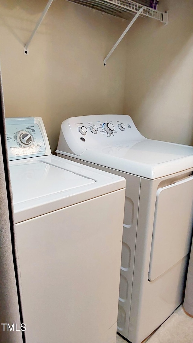 clothes washing area with washer and dryer