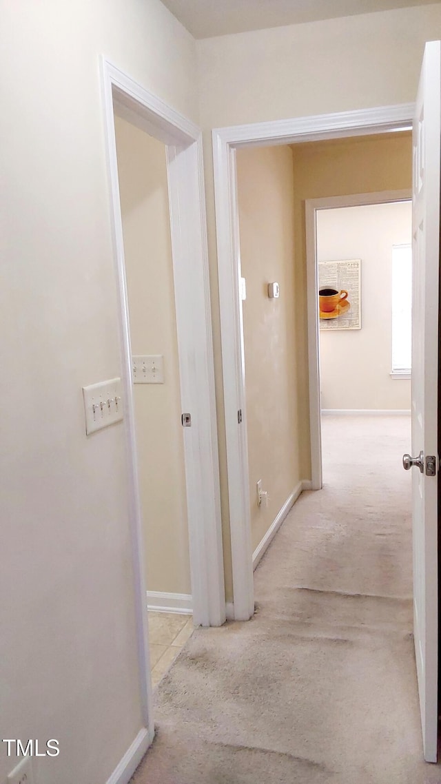 hallway featuring light carpet