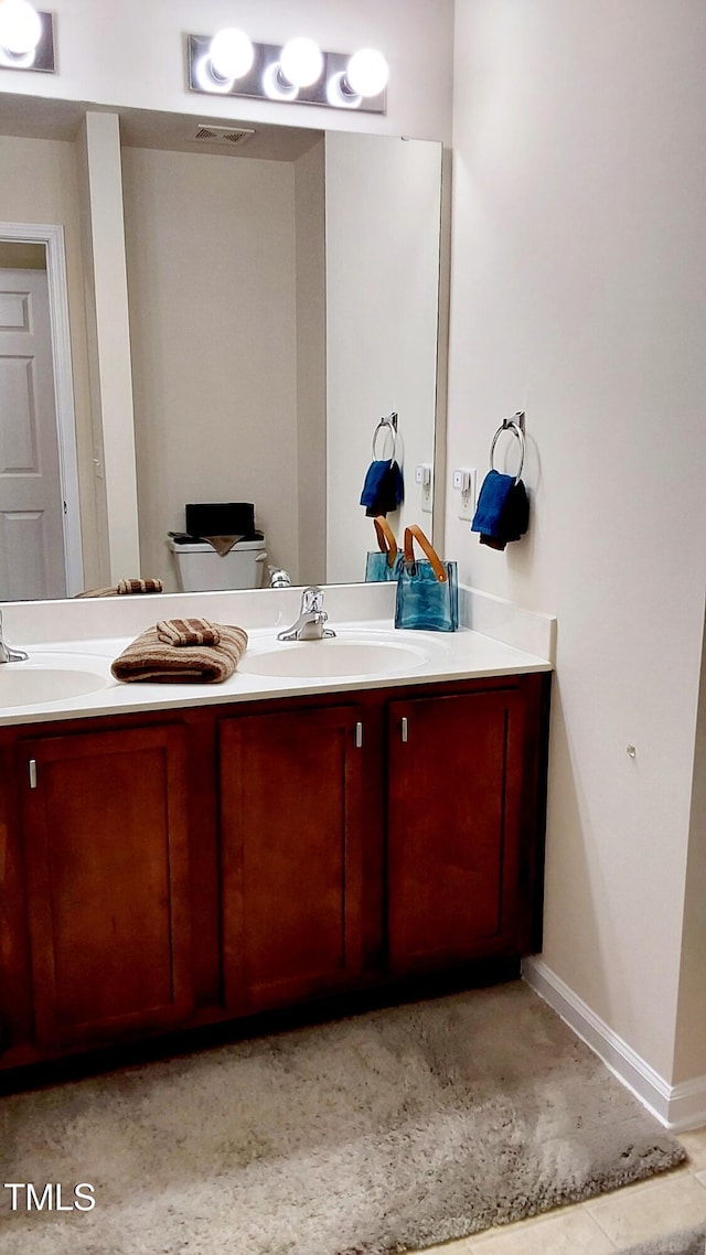 bathroom featuring concrete flooring, vanity, and toilet