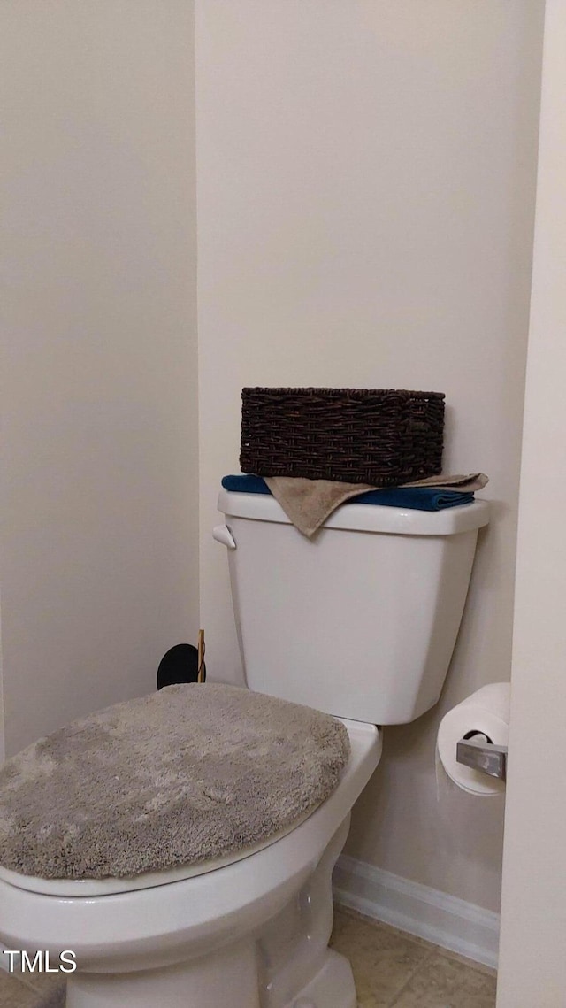 bathroom featuring toilet and tile patterned floors