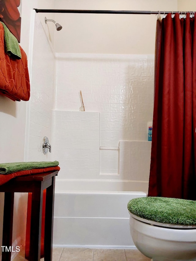 bathroom featuring toilet and tile patterned flooring