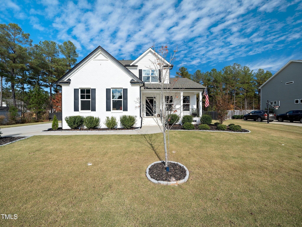 view of front of house with covered porch and a front yard