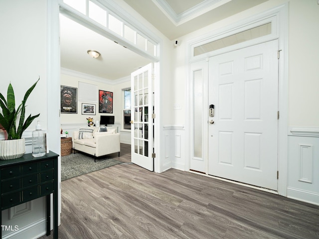 foyer entrance featuring ornamental molding and hardwood / wood-style flooring