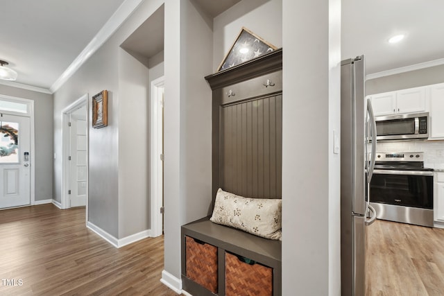 mudroom featuring light hardwood / wood-style flooring and ornamental molding