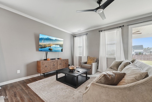 living room with ornamental molding, ceiling fan, and dark hardwood / wood-style floors