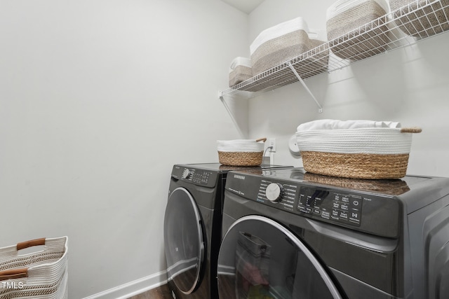 clothes washing area featuring hardwood / wood-style flooring and washing machine and clothes dryer