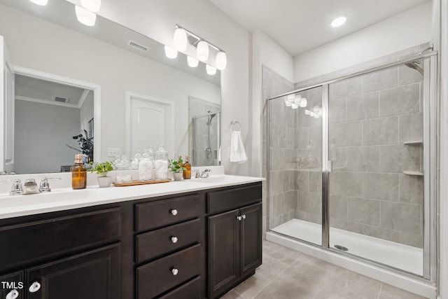 bathroom featuring vanity, an enclosed shower, and tile patterned floors