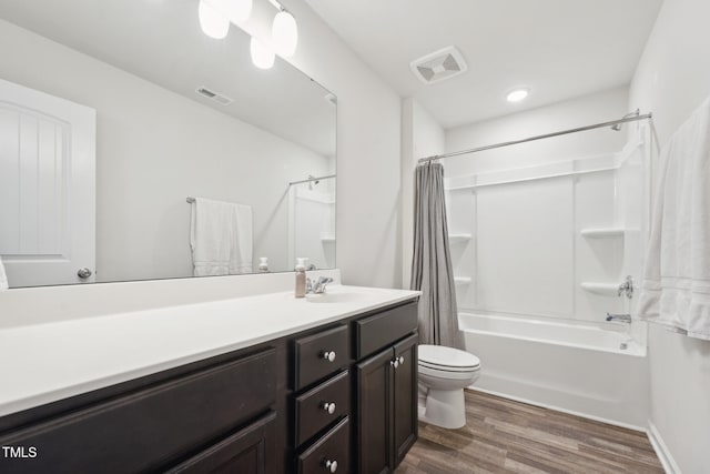 full bathroom with vanity, hardwood / wood-style floors, toilet, and shower / bath combo