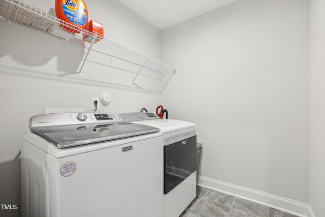 washroom with washing machine and clothes dryer