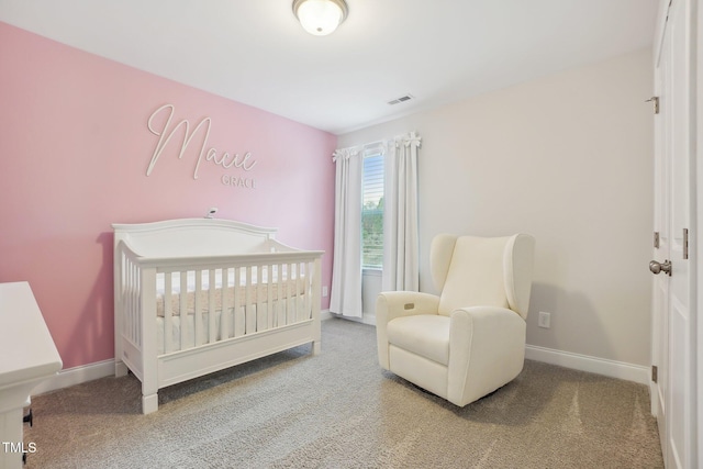 carpeted bedroom featuring a crib