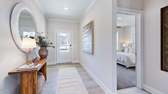 entryway featuring light hardwood / wood-style floors and crown molding