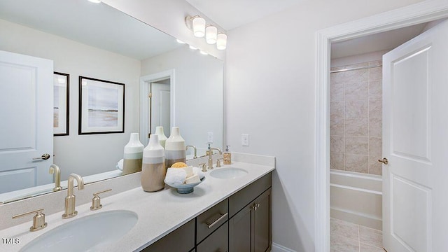 bathroom with tiled shower / bath combo, vanity, and tile patterned floors