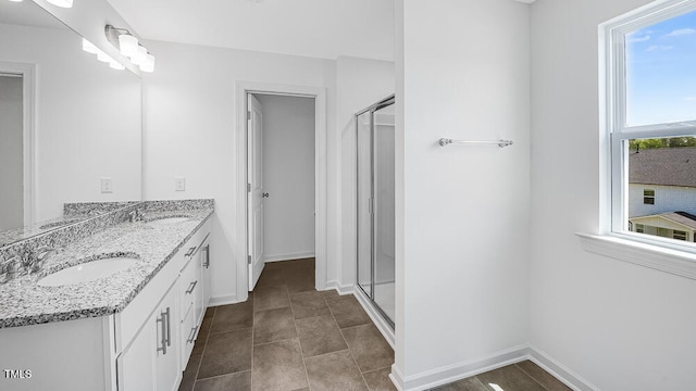 657 Sun Meadow Dr, Wake Forest, NC 27587 - full bathroom featuring a shower stall, double vanity, and baseboards
