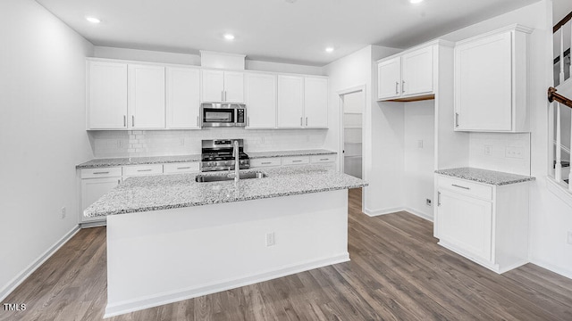 657 Sun Meadow Dr, Wake Forest, NC 27587 - kitchen with stainless steel appliances, a sink, dark wood-style flooring, white cabinets, and recessed lighting
