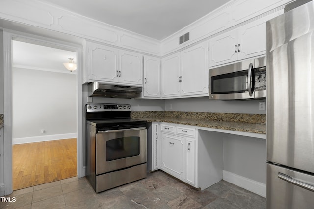 kitchen featuring white cabinetry, appliances with stainless steel finishes, ornamental molding, dark stone countertops, and hardwood / wood-style floors