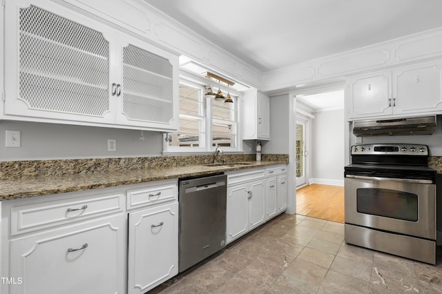 kitchen featuring crown molding, white cabinetry, appliances with stainless steel finishes, sink, and dark stone countertops