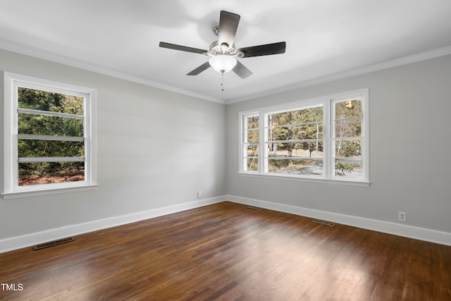 unfurnished room featuring dark hardwood / wood-style flooring, ceiling fan, a wealth of natural light, and ornamental molding