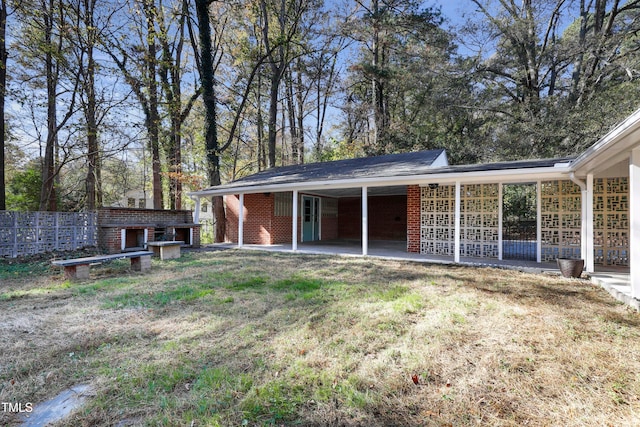 rear view of house featuring a yard