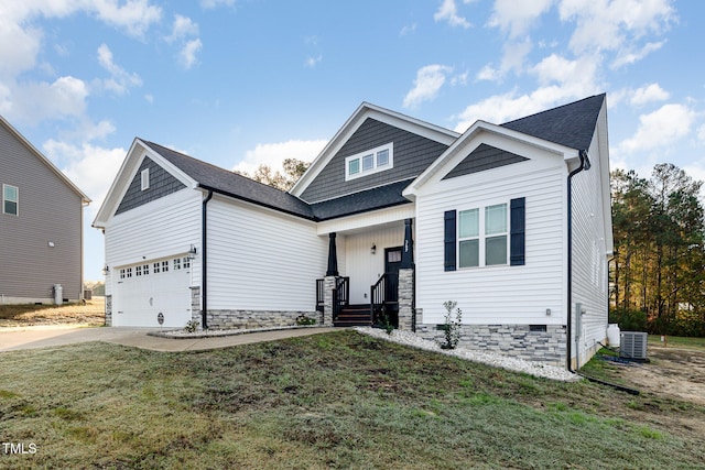 view of front facade with central AC, a garage, and a front lawn