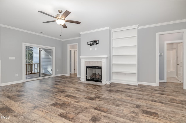 unfurnished living room featuring hardwood / wood-style floors, ceiling fan, crown molding, and a tile fireplace