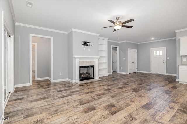 unfurnished living room with hardwood / wood-style floors, ceiling fan, and ornamental molding