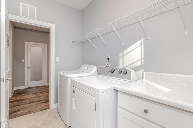 washroom featuring washer and dryer and light hardwood / wood-style flooring