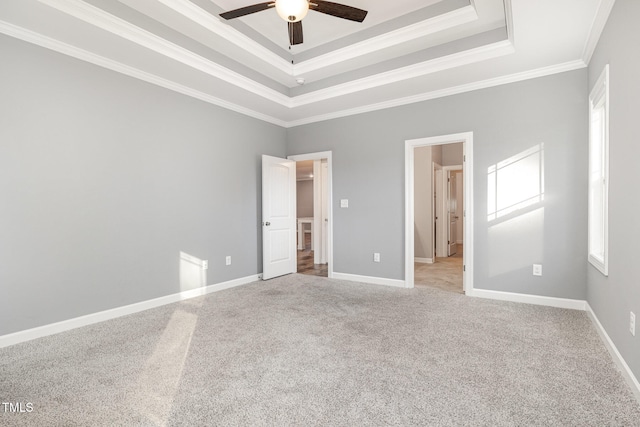 unfurnished bedroom with ceiling fan, a raised ceiling, ornamental molding, and light carpet