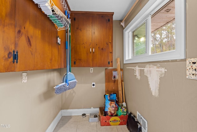 laundry area featuring light tile patterned floors and electric dryer hookup