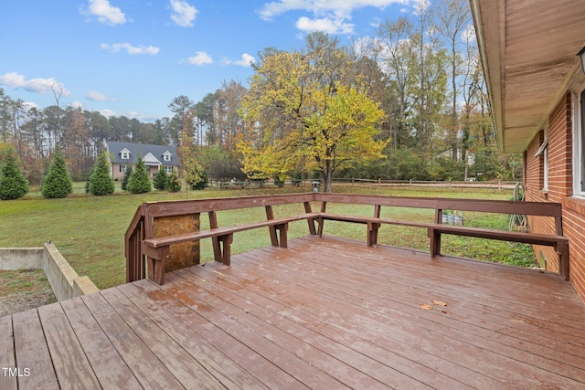 wooden deck featuring a yard