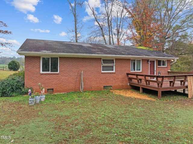 back of property with a lawn and a wooden deck