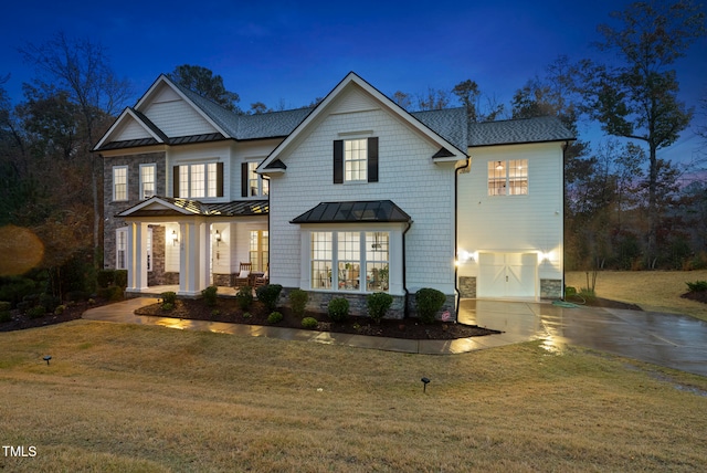 view of front property featuring a garage and a front lawn