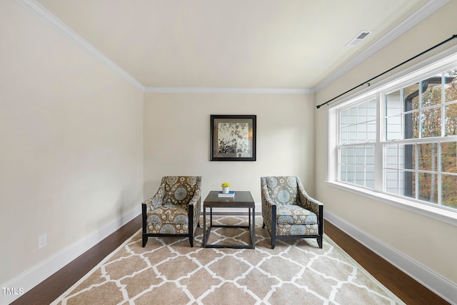 living area featuring crown molding and hardwood / wood-style floors