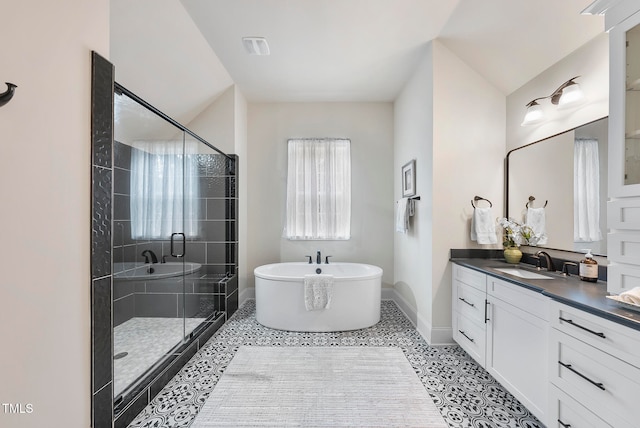 bathroom with tile patterned flooring, vanity, separate shower and tub, and vaulted ceiling