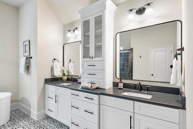 bathroom featuring tile patterned floors, vanity, and vaulted ceiling